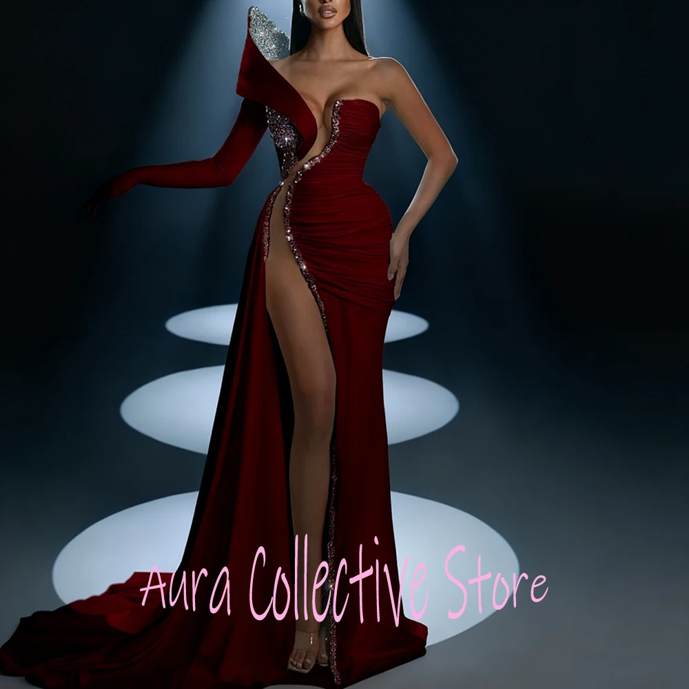 

Burgundy One-Shoulder High Slit Sheath Evening Dress with Crystal Embellishments One Long Sleeve Floor Length Cut Out Sexy Gown