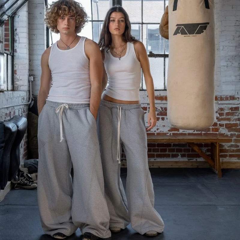 Pantalones de chándal con cordón y patrón bordado de estilo americano para hombres y mujeres, pantalones informales sueltos de pierna ancha de Hip-hop de calle alta para parejas