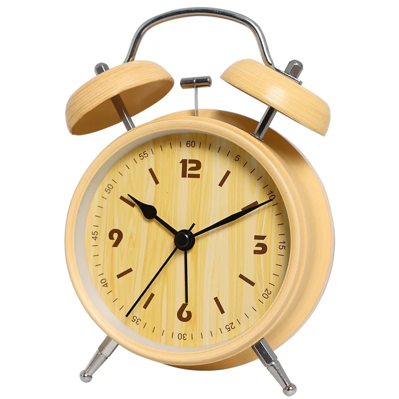 Mini alarm clock rings. Silent electronic clock for bedroom. Student's wake-up device. Nightlight clock