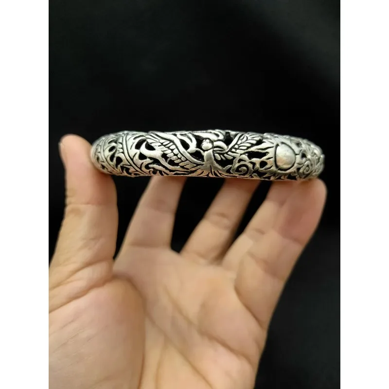 Handcrafted Tibetan silver dragon and phoenix leaky bracelet with unique ethnic style and craftsmanship as a gift