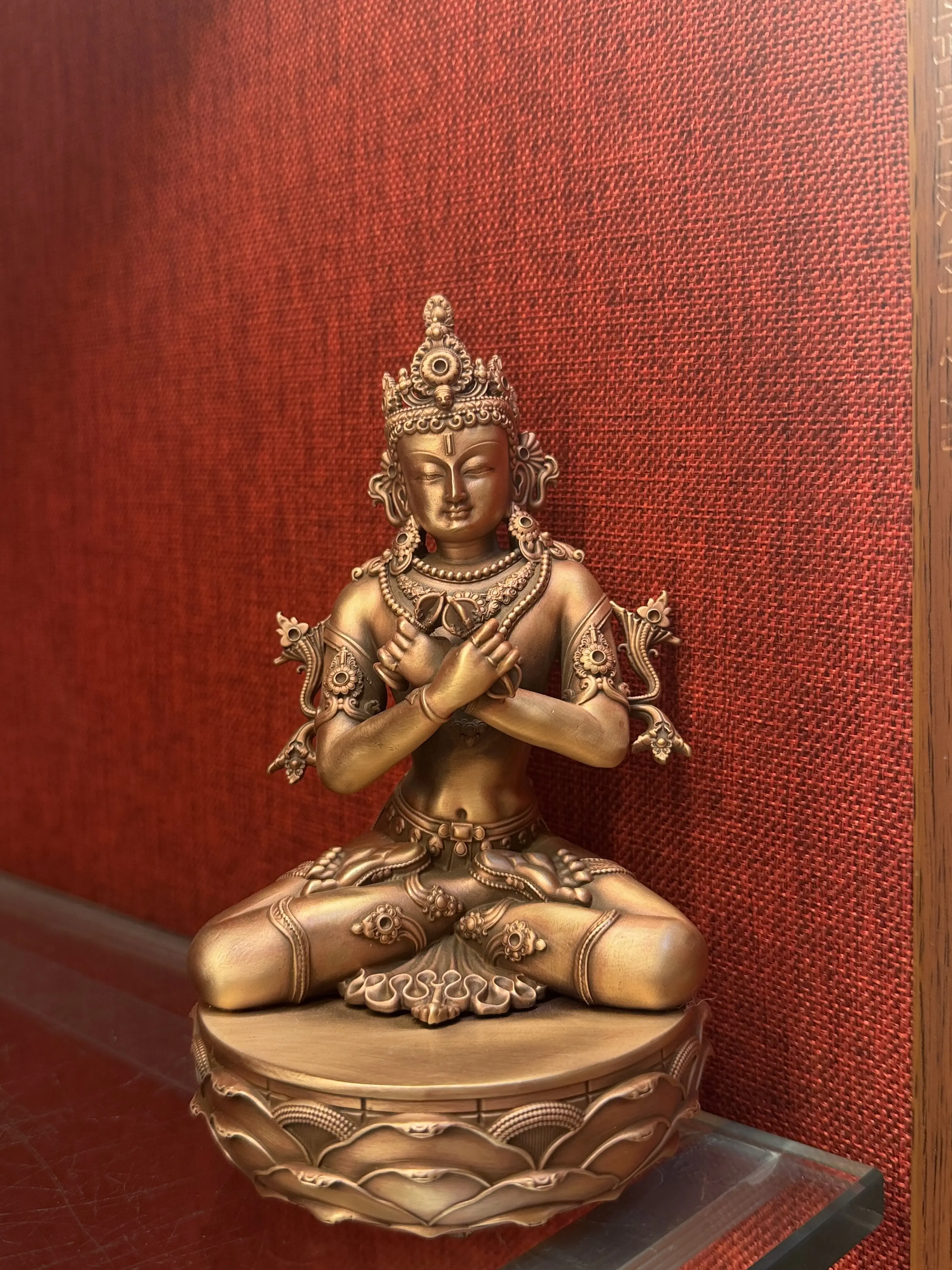 The Vajra Zongzha is a pure red copper Buddha statue from the Zhana Baza period, standing 15 centimeters tall
