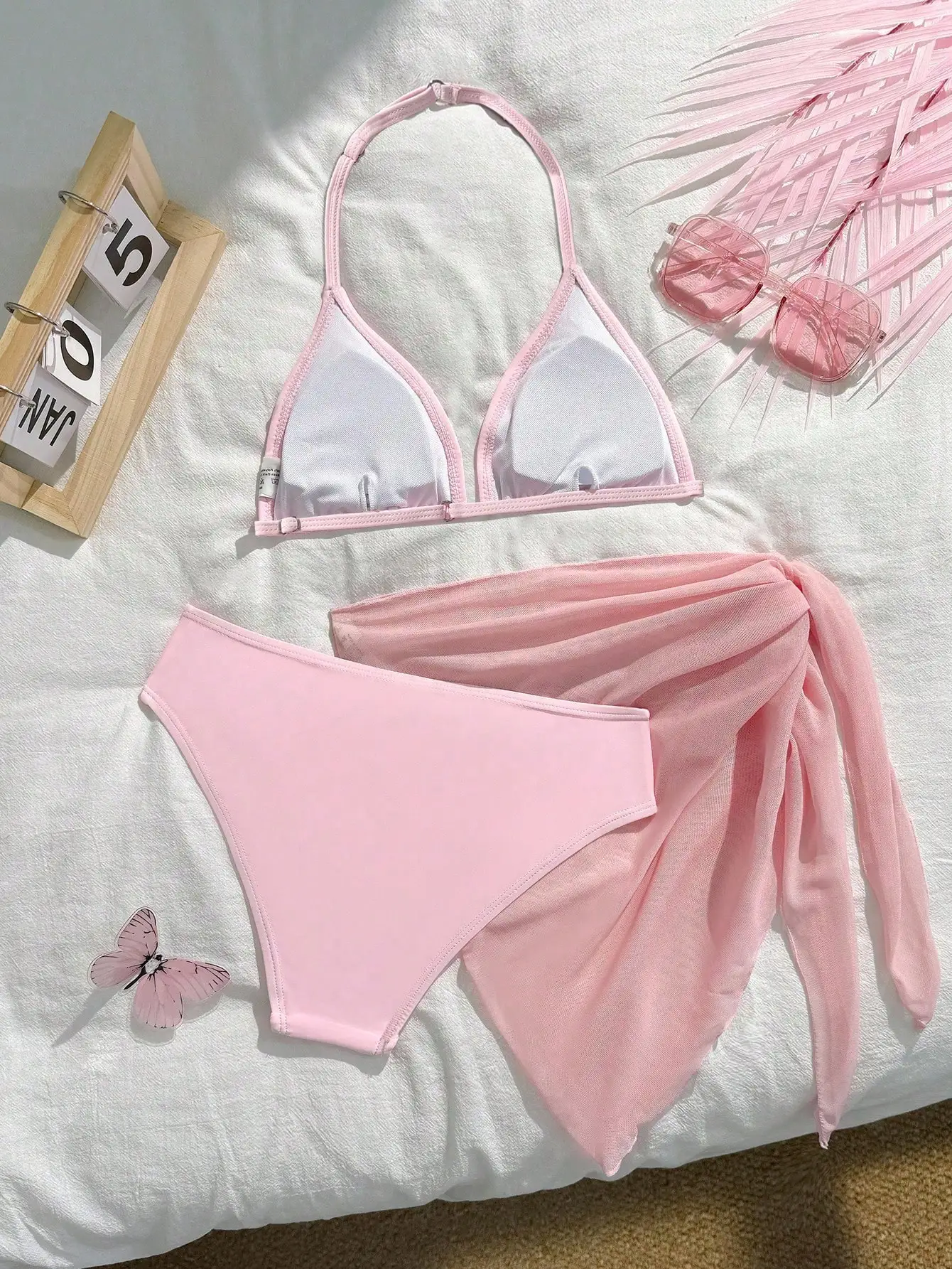 Stylish Pastel Pink Three-Piece Swimwear Set Featuring Halter Triangle Top, High-Waist Bottom, And Flowy Sheer Wrap Skirt
