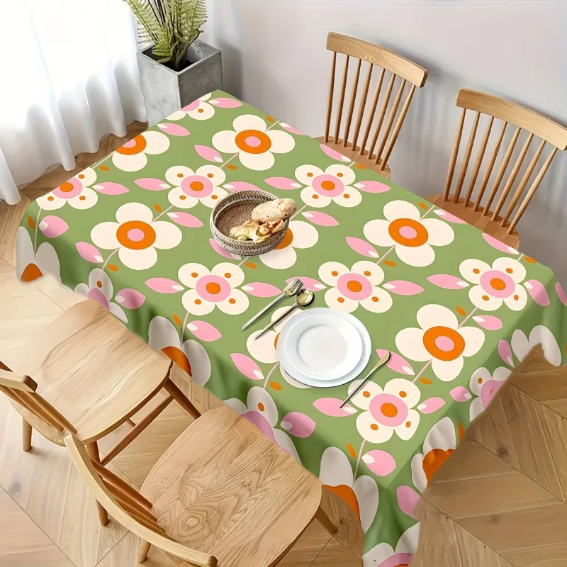 One vintage floral tablecloth, with bright green and colorful floral patterns on it.
