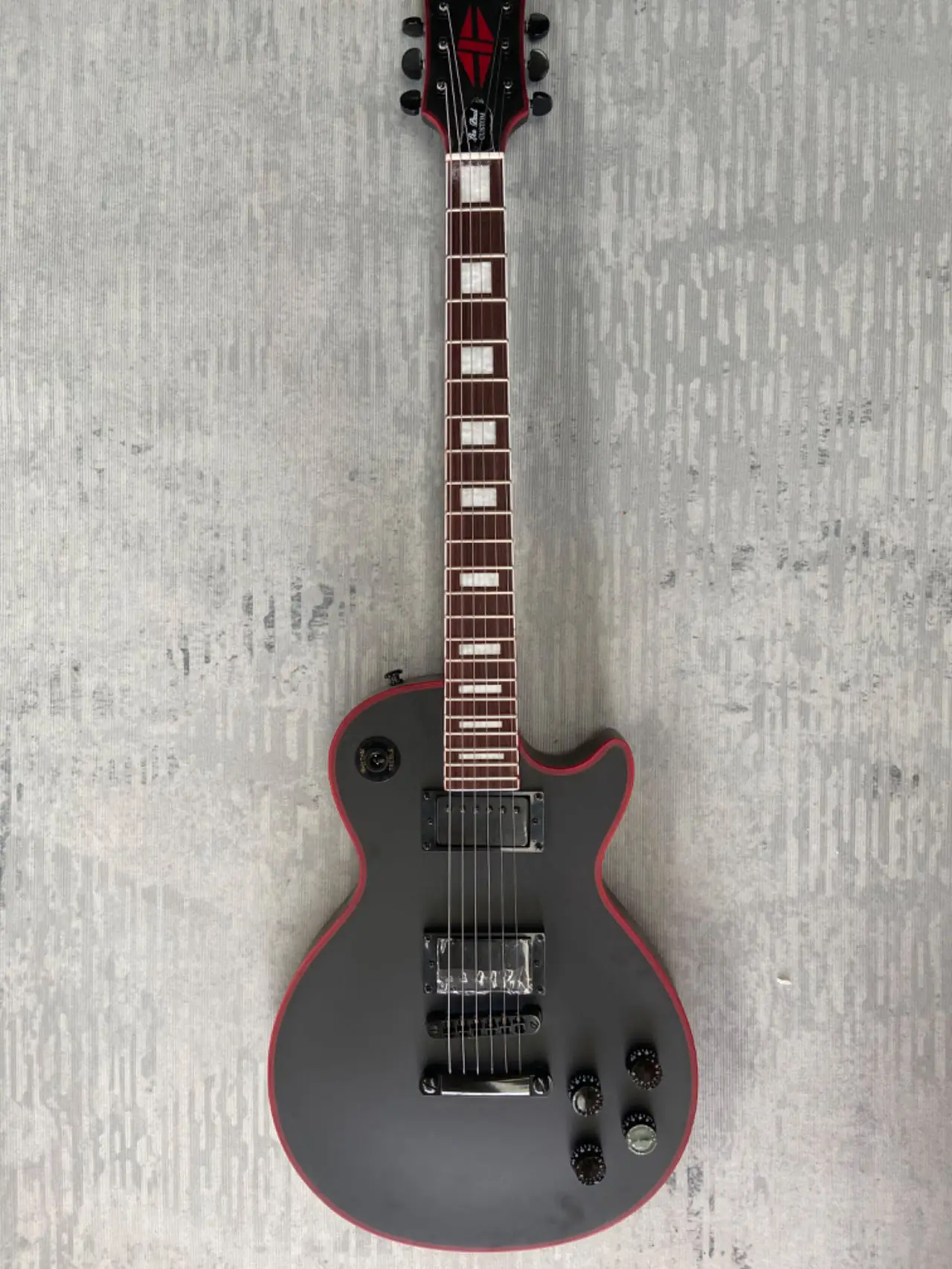 have Gib~ logo Electric Guitar, Black, Red binding, Red logo Jacob, Mahogany body, Rosewood fingerboard Made in China,