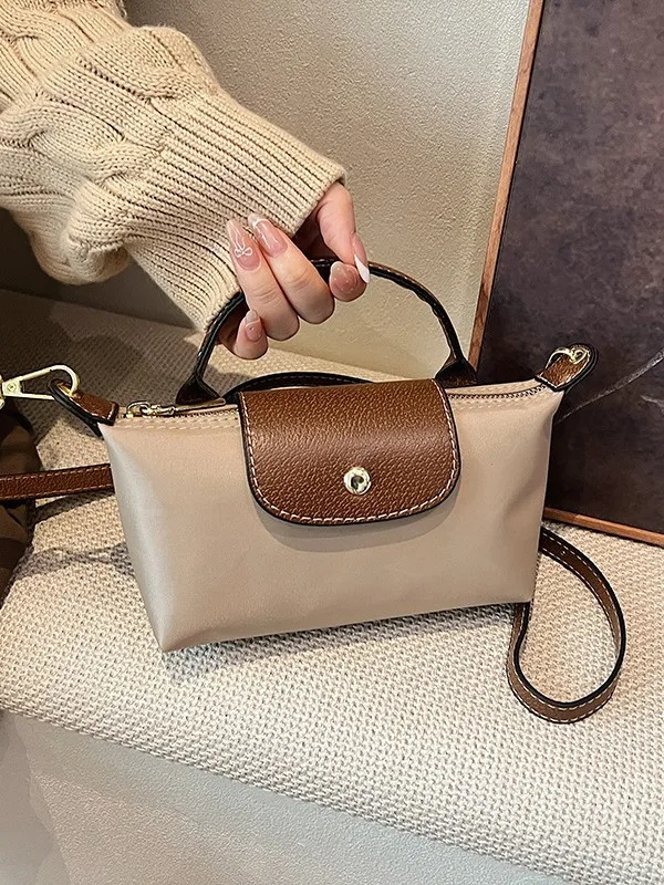 

Retro fashion all-in-one 2025 spring/summer women's bag single shoulder crossbody hand carrying high-grade nylon dumpling bag