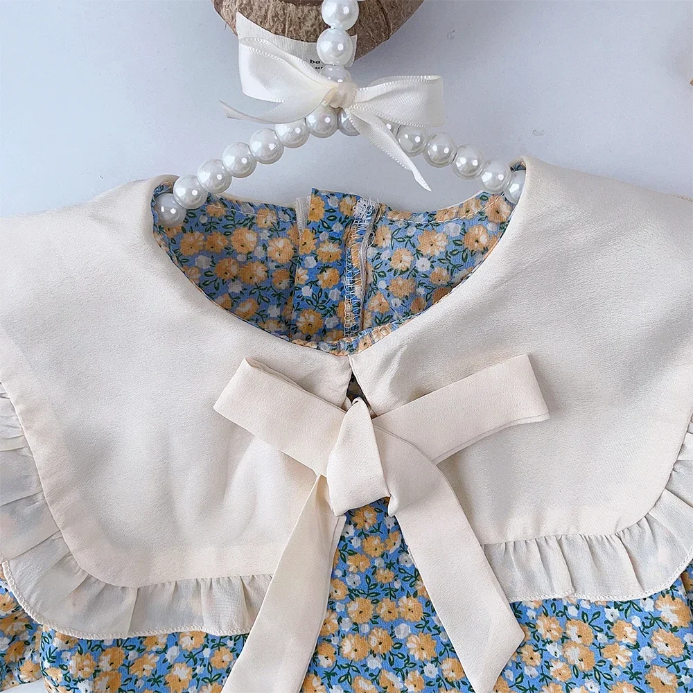 فساتين Bear Leader الصيفية العصرية للفتيات بأكمام قصيرة وطية صدر السترة وديكور فيونكة فستان مطبوع عليه زهور