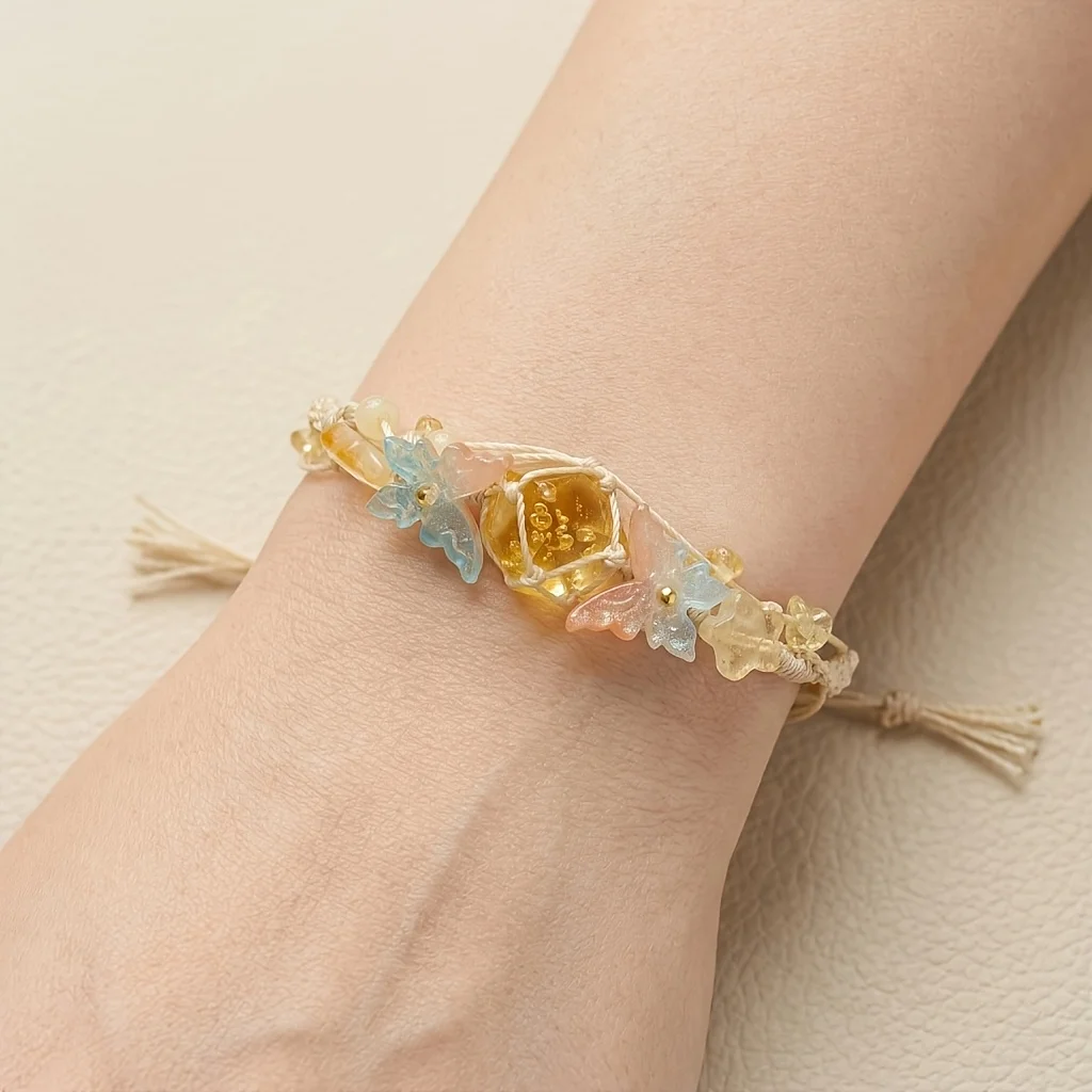 Bohemian double-layer woven bracelet with synthetic citrine, off-white cord decorated with butterfly and star beads.