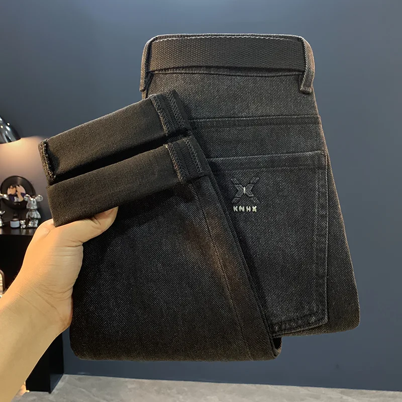 جينز أسود للرجال 2025 خريف جديد ملابس للرجال الراقية العلامة التجارية العصرية القدم الصغيرة عادية مطاطا بنطال ملاصق للجسم