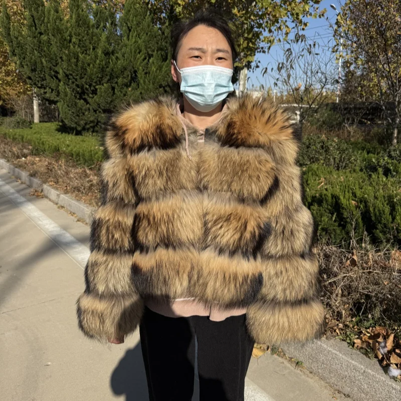 

A warm winter long-sleeved fur coat made from pure natural raccoon fur, and a high-quality women's leather jacket