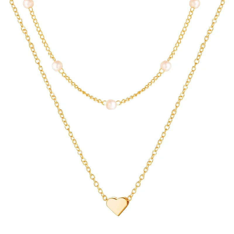 

Stylish, trendy, and elegant layered freshwater pearl necklaces plated with 14K gold - adorned with unique heart pendants on a c