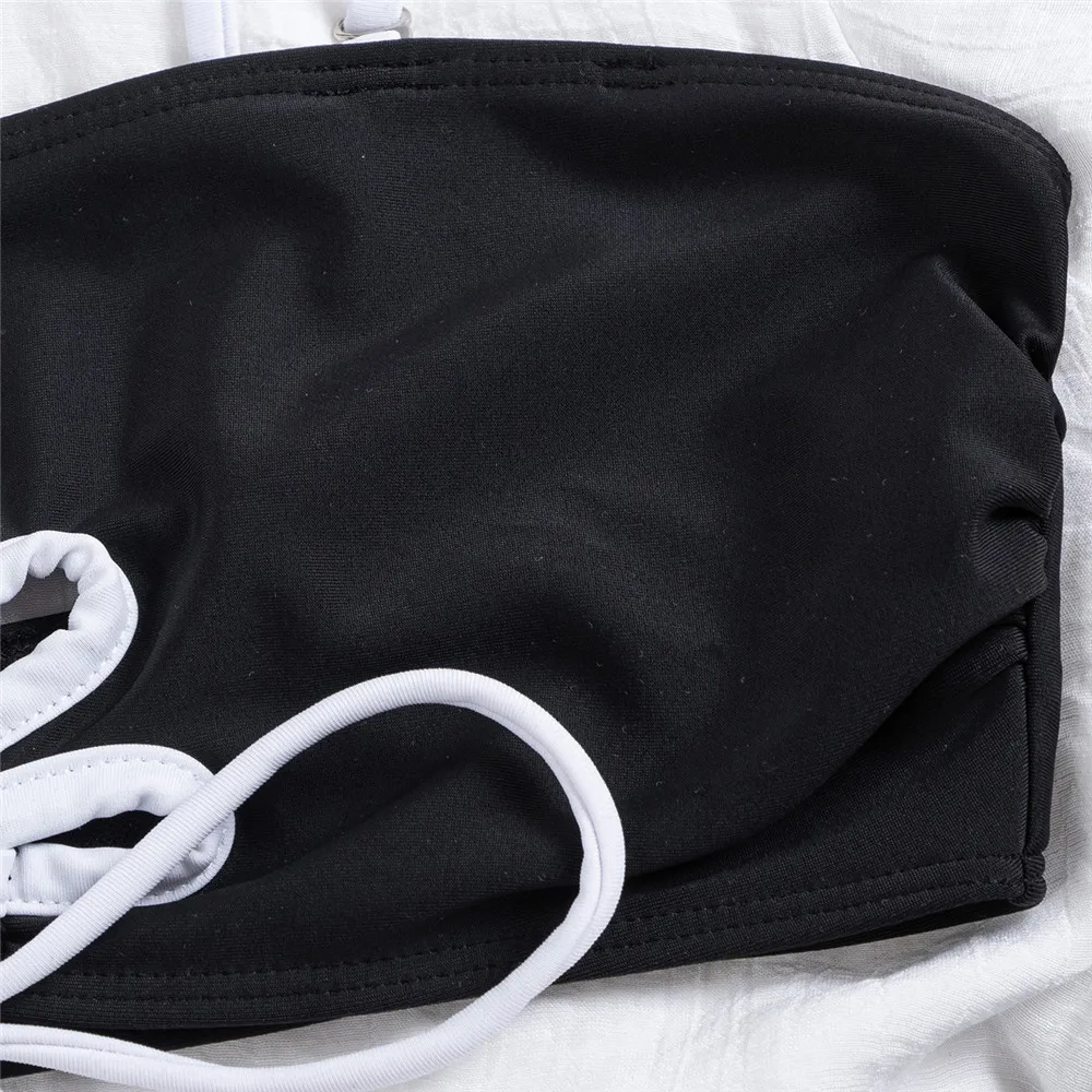 أطقم بيكيني باللون الأسود والأبيض المتباين مع سلسلة برباط علوي ملابس سباحة مثيرة للنساء 2025 ملابس سباحة للسيدات مفرغة