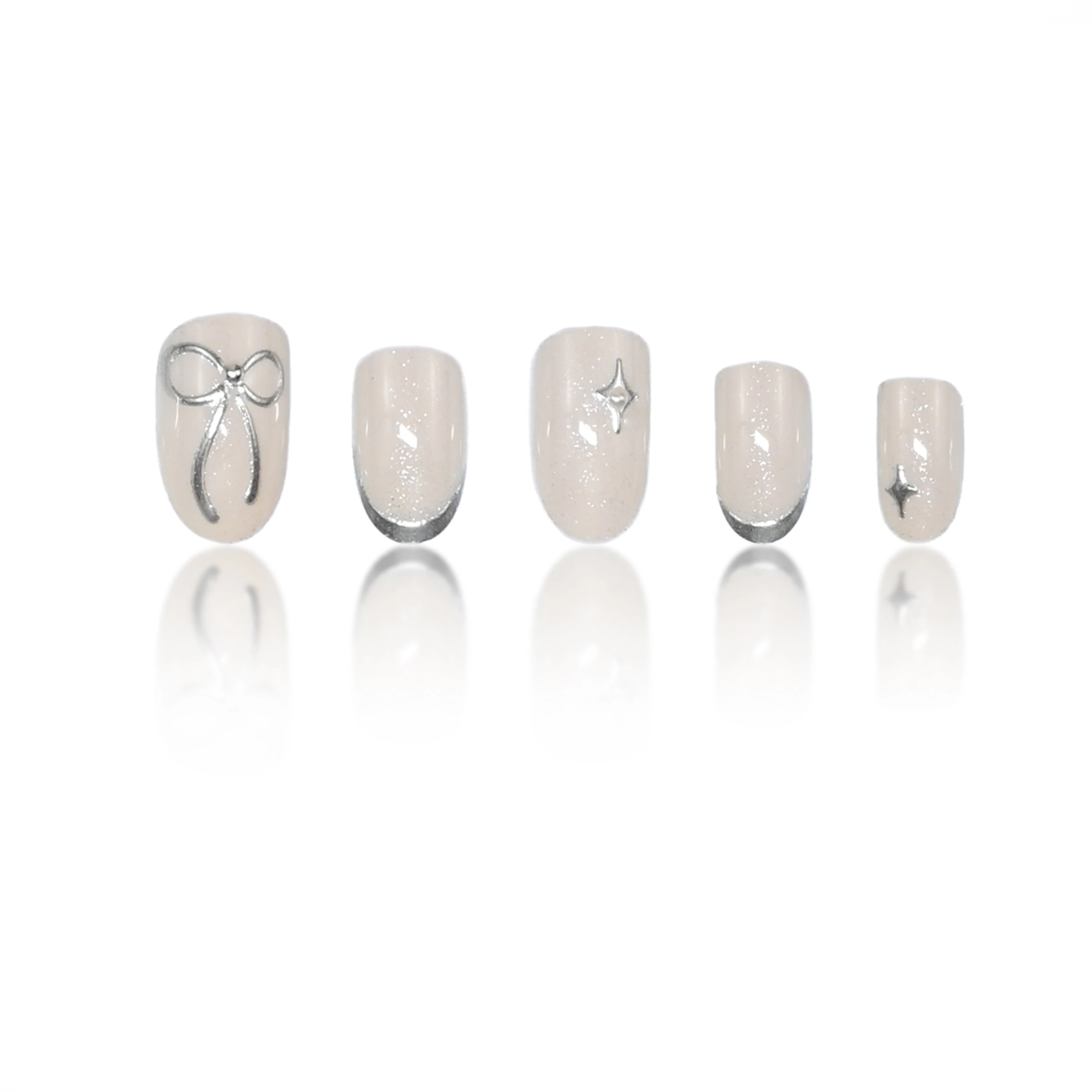 24pcs handmade short round press-on nails. Shimmer cream base with silver French tips, 3D bows & star studs. Reusable, ideal for view 3