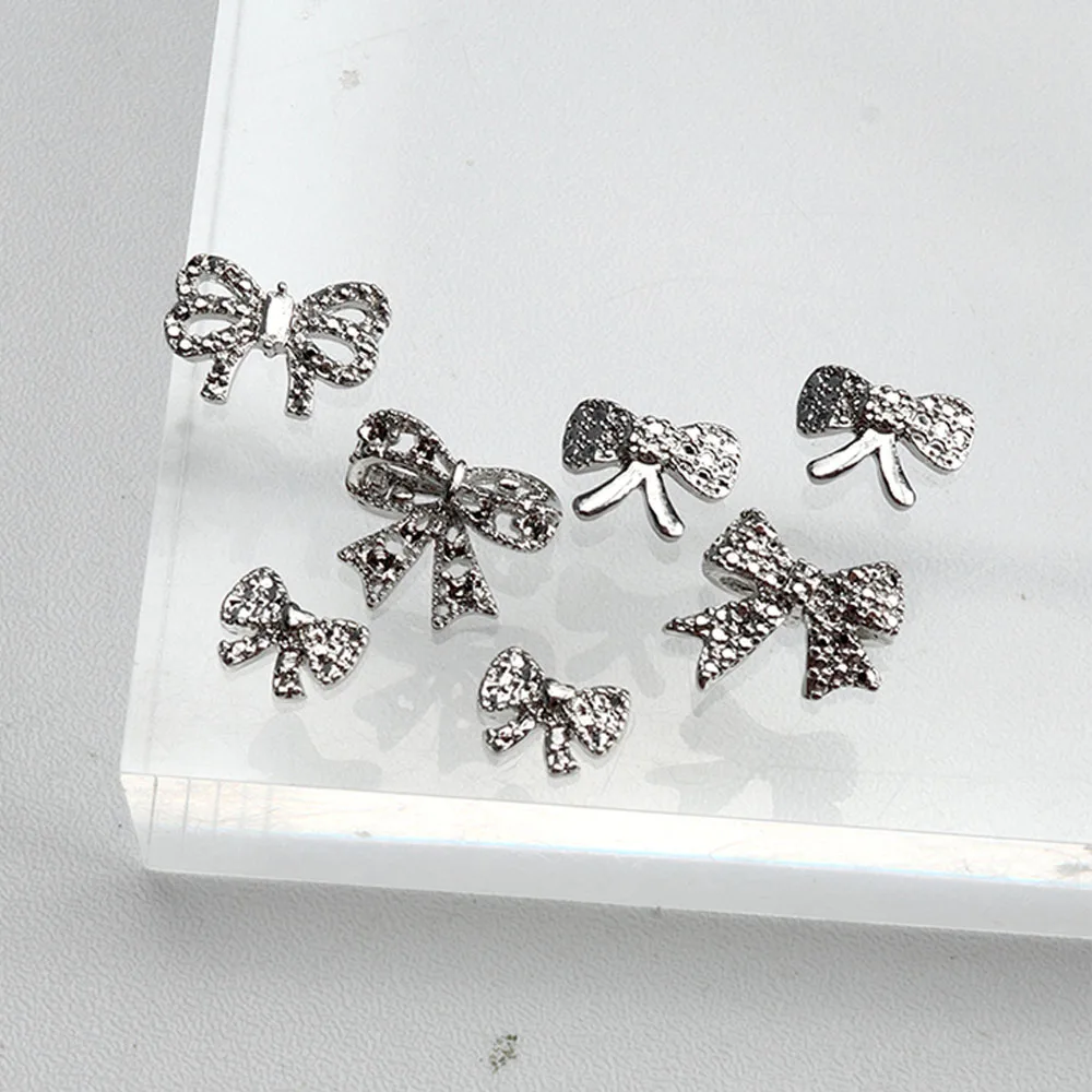 10 Uds. De pajarita plateada Retro de Metal para decoración de uñas, joyería torcida de aleación 3D, dijes para uñas, suministros de accesorios de manicura exquisitos DIY