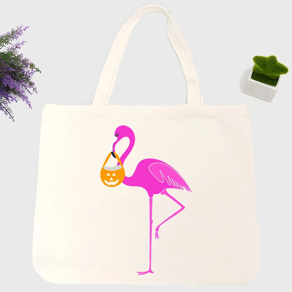 Women's flamingo graphic canvas tote bag with pumpkin design, casual style for Halloween and daily shopping