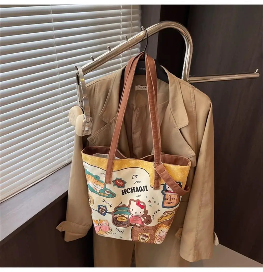 

Cute cartoon KT cat canvas bag for women 2025 new large capacity single shoulder bucket bag, student class tote bag