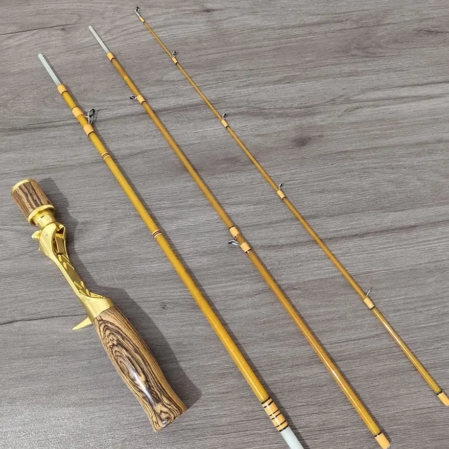 

A miniature recessed fishing rod assembly with a handle, featuring a bell-shaped part, suitable for fiberglass fishing rods.
