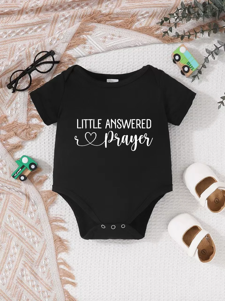 Playful letter-printed baby short-sleeve triangle bodysuit. Button closure for easy dressing