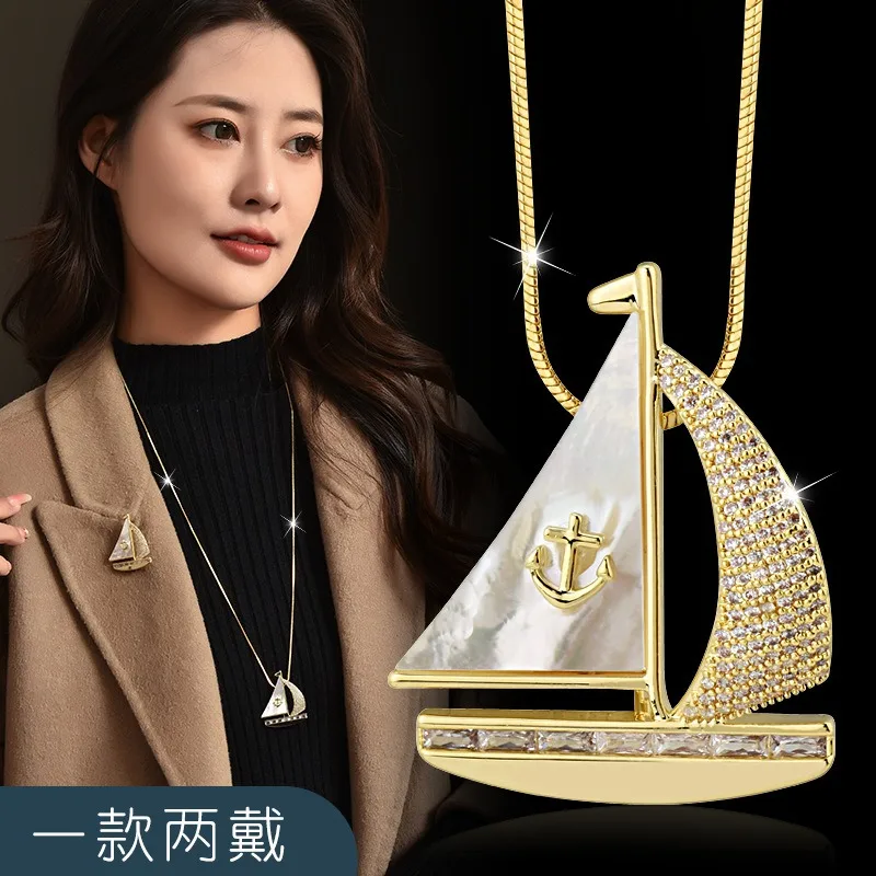 秋冬の新しいロングネックレス、セーリングボート風のセーターチェーン、ツーピースドレス用のコサージュブローチ