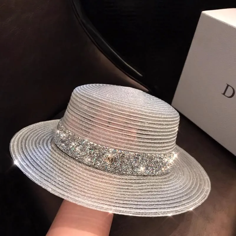 

A women's hat with flat top and two elegant white hats for seaside vacation