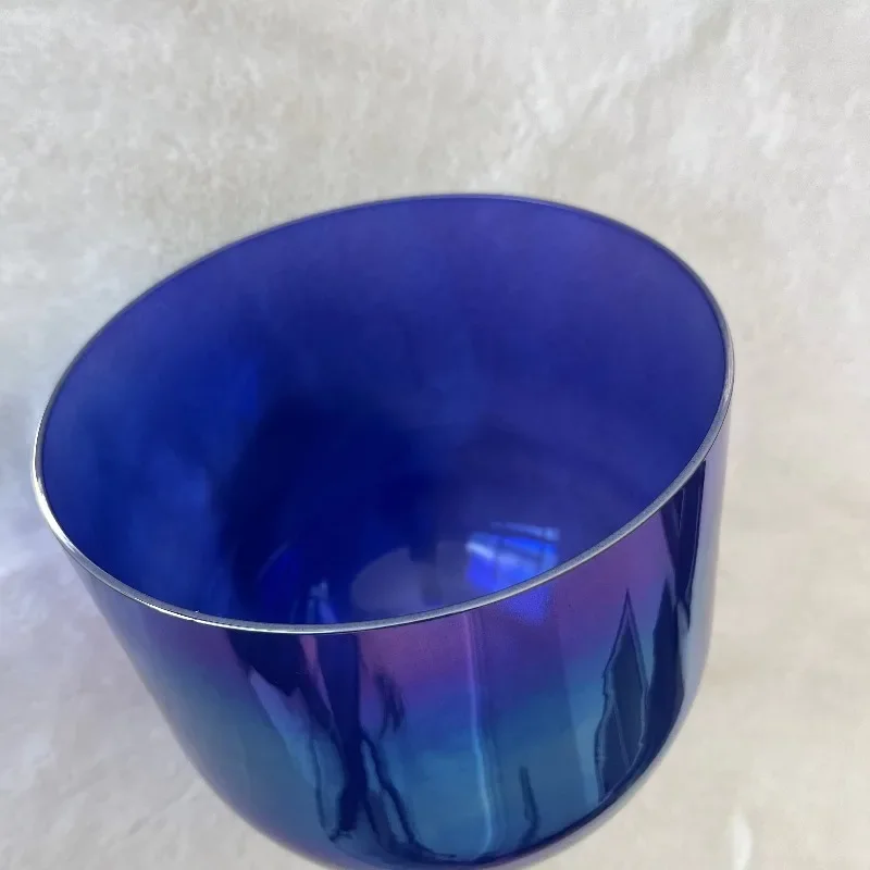 Electric blue crystal singing bowl with handle for sound restoration
