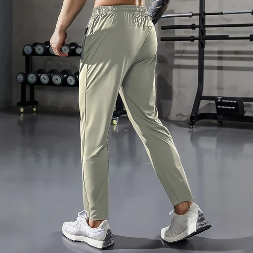 Imagen 2 del producto [Relación casera] Pantalones deportivos informales para hombre, tela tejida de alta elasticidad, color sólido, ajuste regular con cordón en la cintura y cremallera