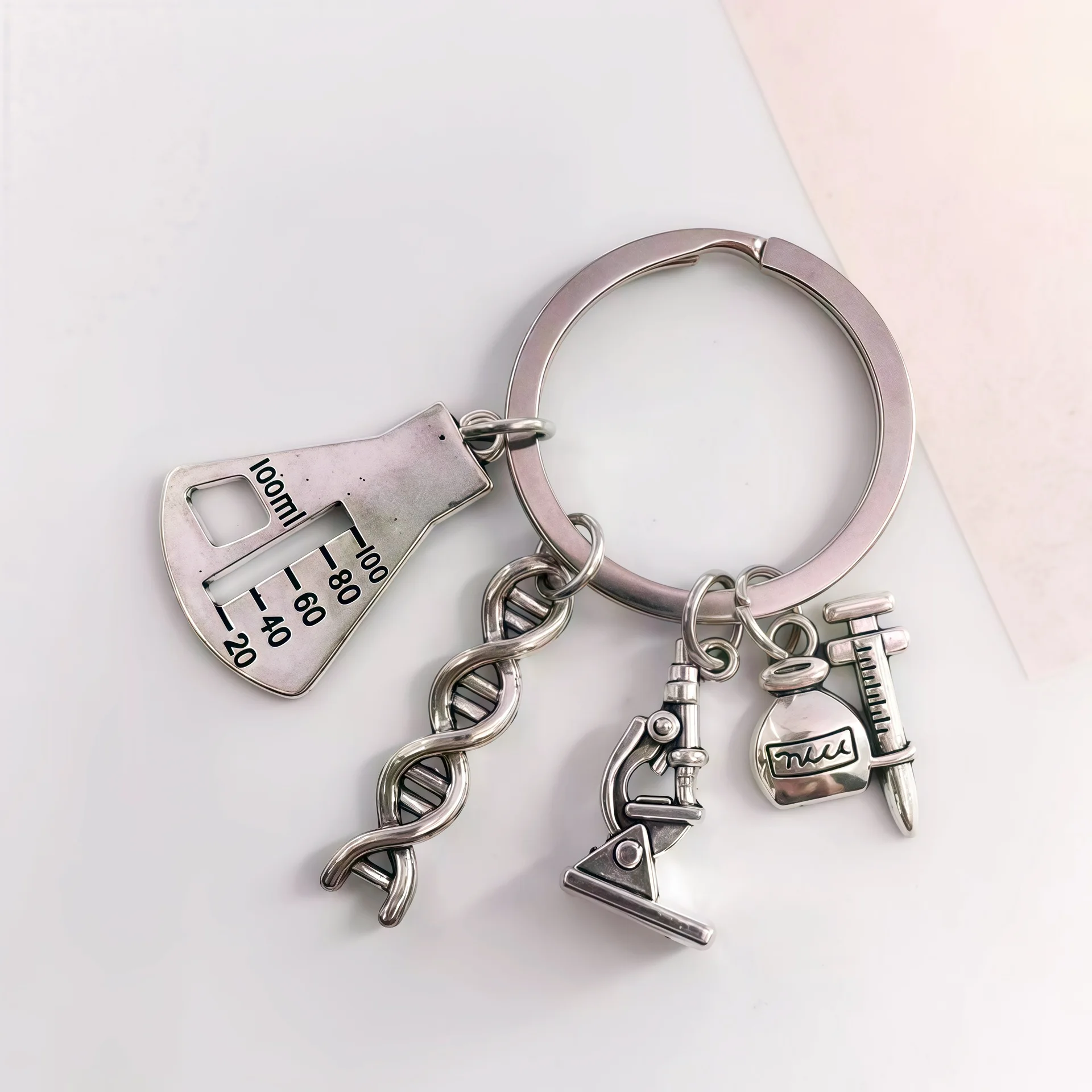 Creative design of experimental tool combination: practical daily keychain featuring DNA, flask, and microscope accessories
