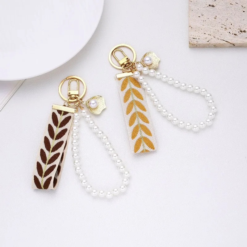 Trending 2025 Keychain Set Fashion Minimalist Pearl Car Keychain Woven Stripe Bag Charm Elegant Women Keychain Organizer Gift