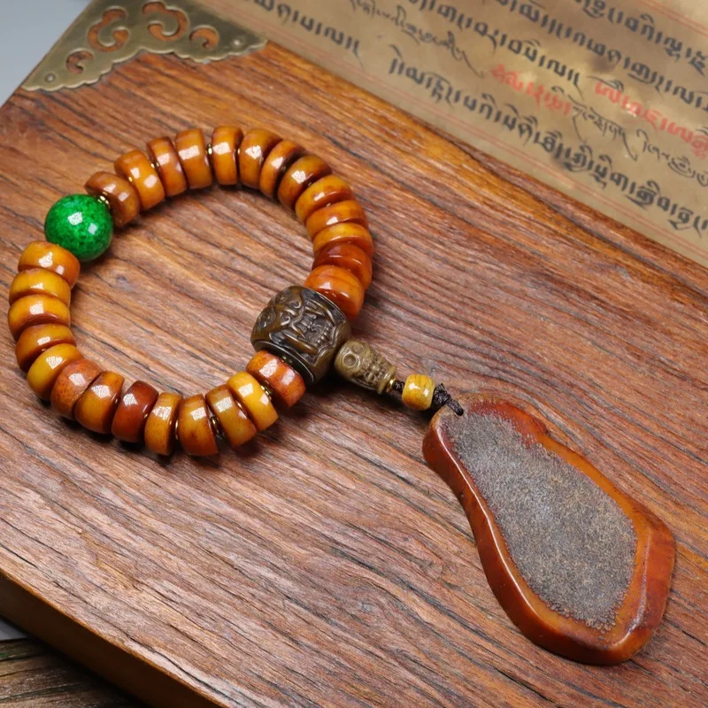 Tibetan old bracelet with handcrafted distressed barrel beads and a six-syllable mantra