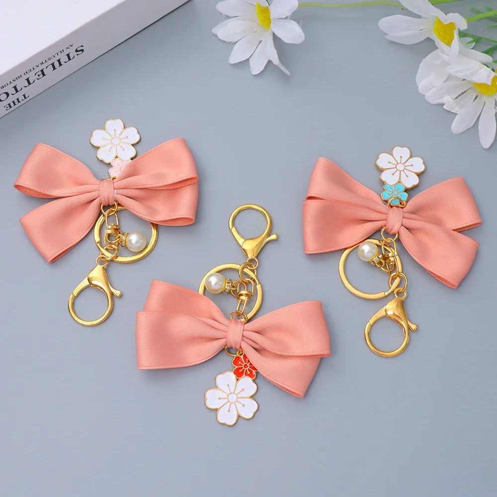 Cute Sakura Bowtie Keychain Fashion Pearl Chain Handbag Charm Car Keyring Earphone Case DIY Ornament for Women Souvenir Jewelry