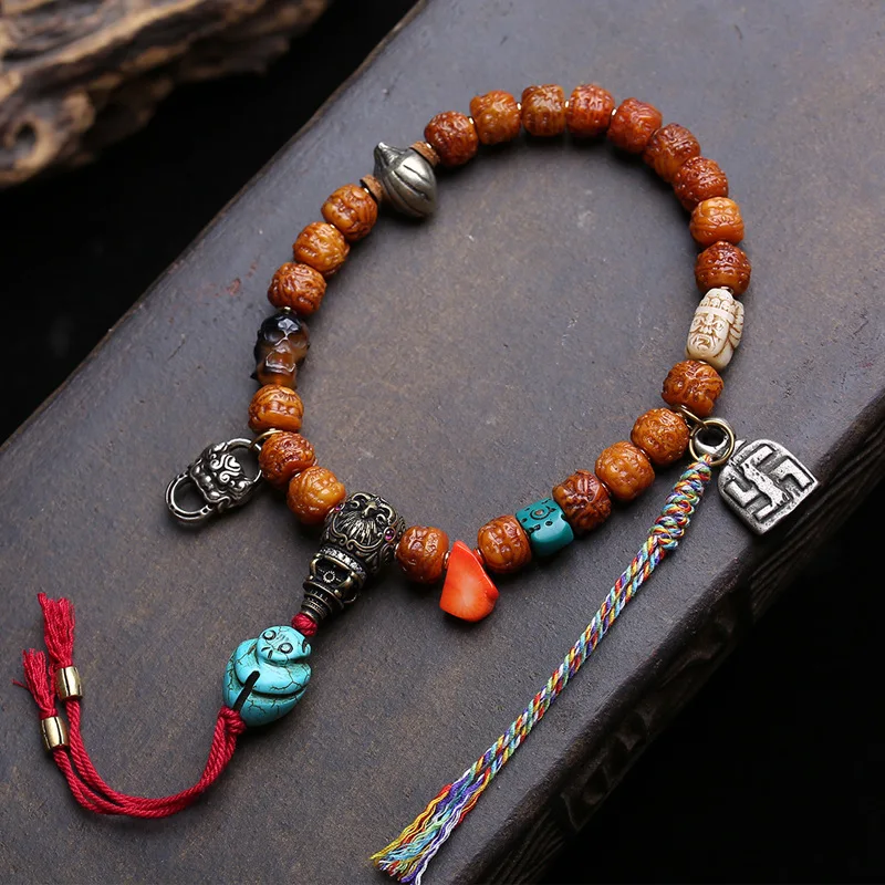 Yak bone carving of Zaki Ram  a cultural artifact from past present with a hand-held copper -tsa and three-way clip acce