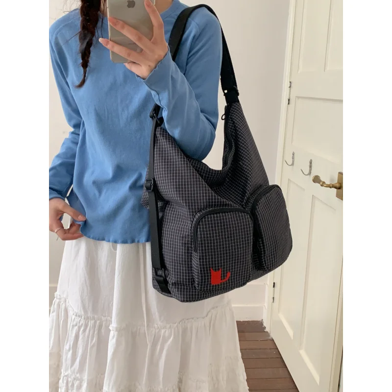 Trendy niche plaid multi-pocket backpack for women2026New large-capacity multifunctional casual commuter canvas bag