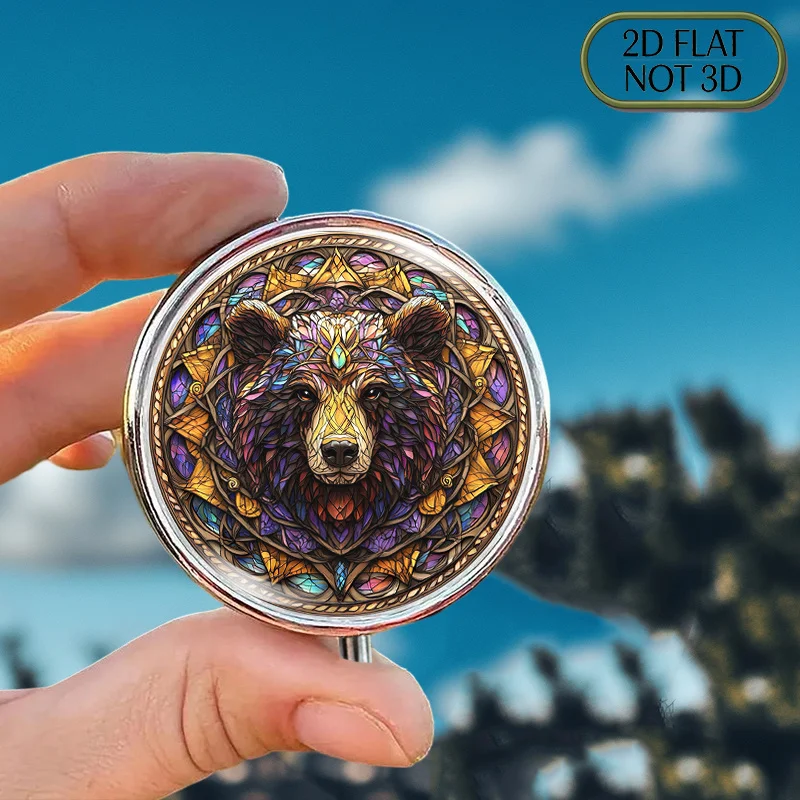 A flat, portable, round metal pill box, adorned with a vibrant stained glass pattern of a Celtic bear head, is an ideal choice for stylishly storing supplements and medicines. It is suitable for vitamin storage, multi-functional storage, or as a thoughtful gift for friends, with a flat design