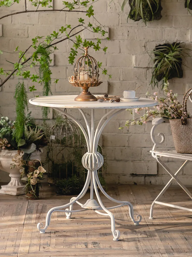 Vintage made old Monet garden outdoor courtyard wrought iron balcony small round table chair