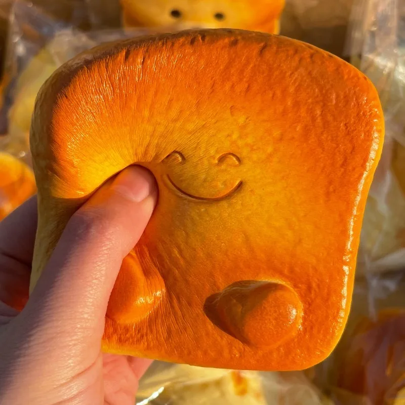 Smiling face,thick toast, kneading,slow rebound,decompression toy,simulated bread,soft,hand kneaded,venting artifact gif