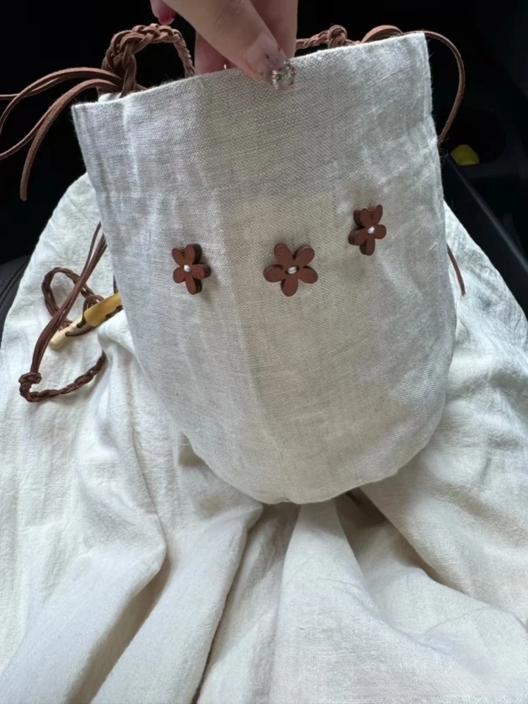 

2025 New Versatile Solid Color Canvas Bucket Bag for Women Flower Decoration Handheld Shoulder Commuter Bags