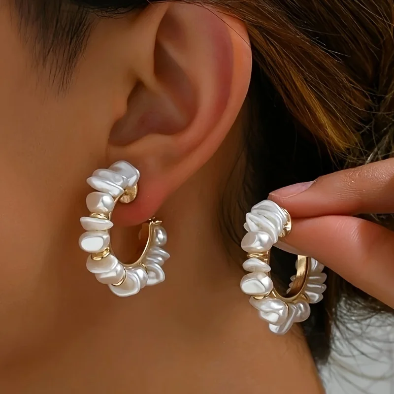 A pair of handcrafted Bohemian-style baroque pearl earrings with a wrapped jewelry design, featuring an Australian white C desig