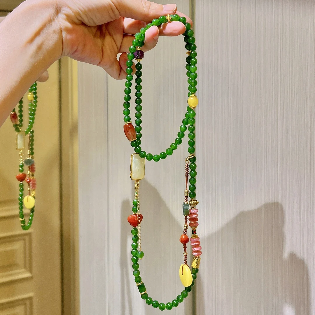 

Natural spinach green jasper necklace female Hetian jade Buddha beads south red stone beeswax Duobao sweater chain wholesale