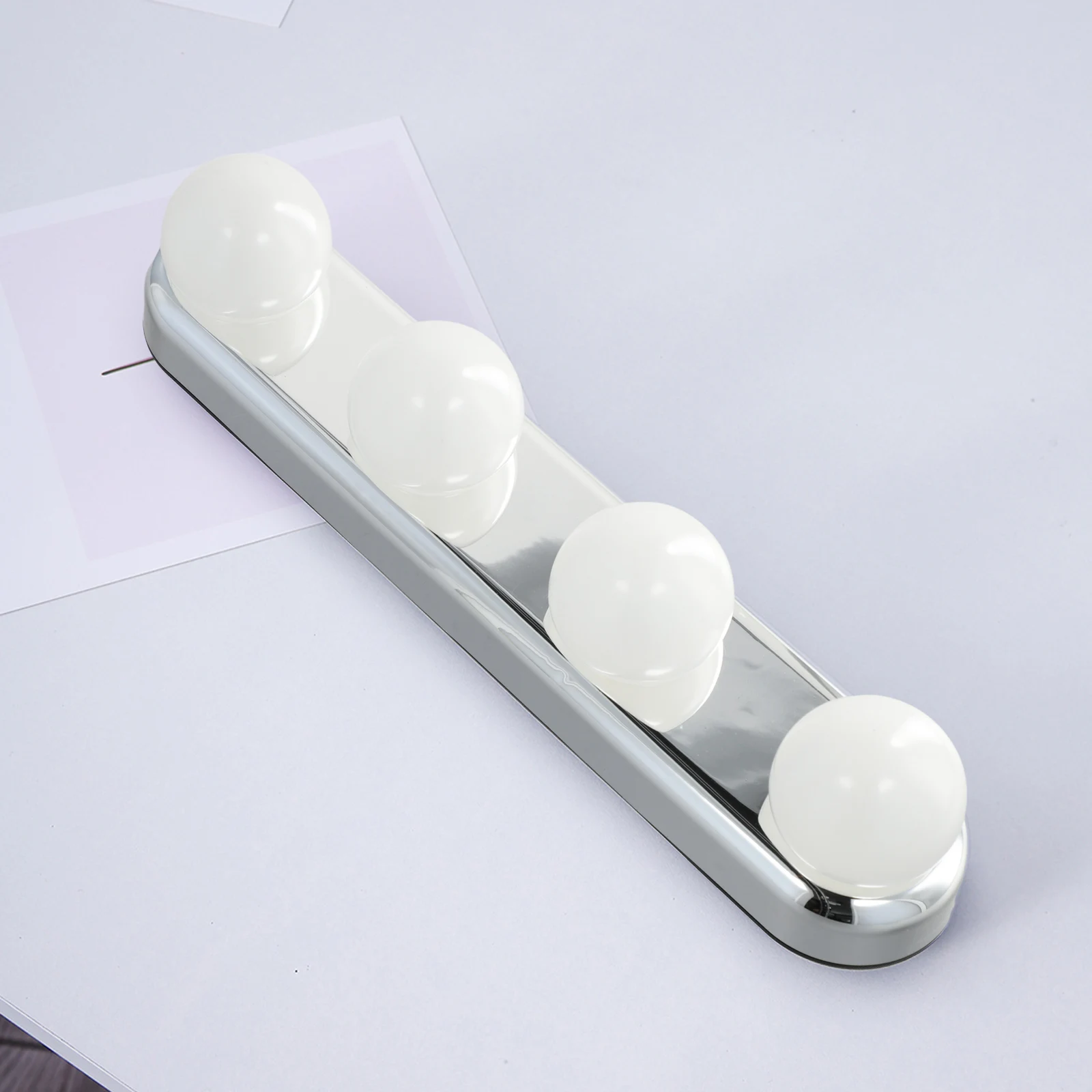 Achieve professional makeup results with this 4 LED lamps mirror light that easily attaches to mirrors and tiles