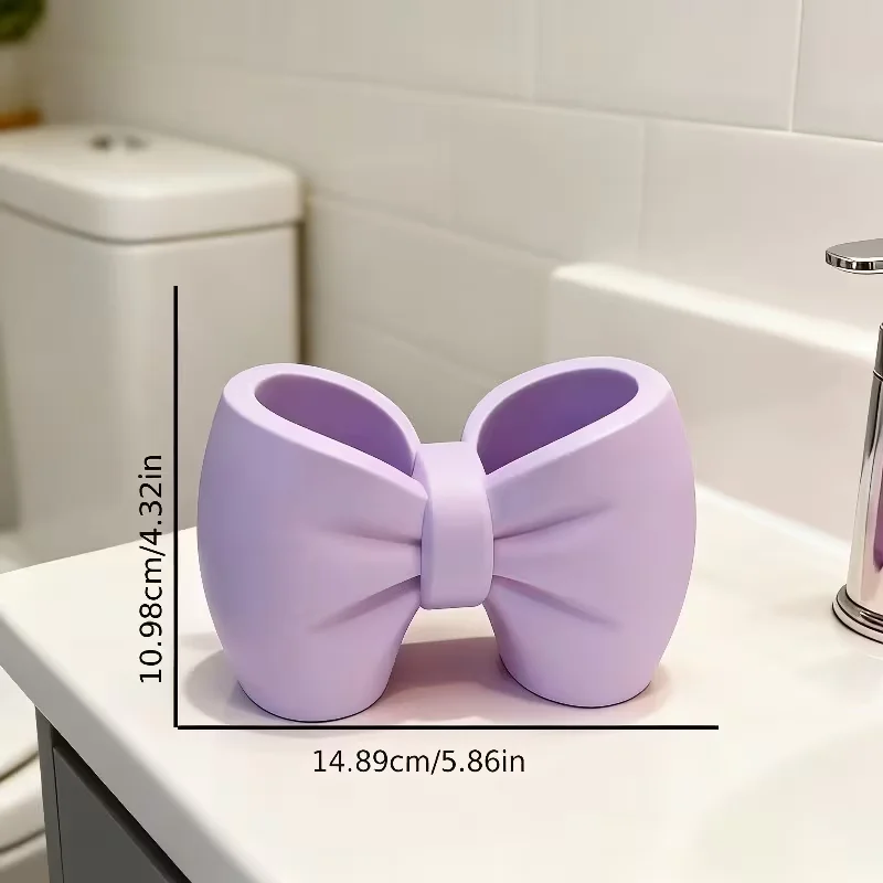 A desktop decoration item, shaped like a macaron-colored bow, can be used as a pen holder.
