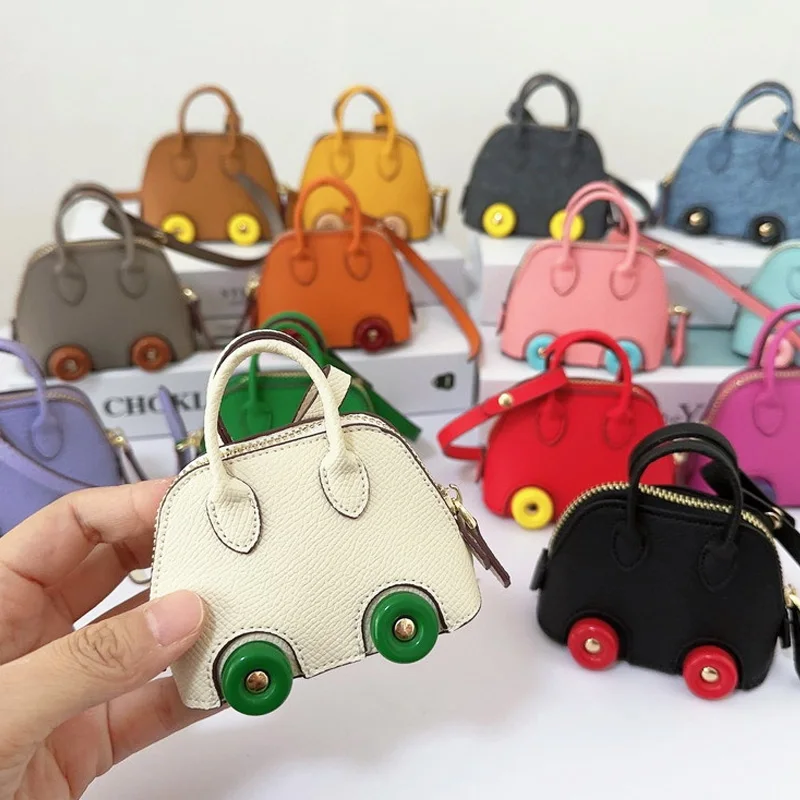 Mini bolso con ruedas de cuero PU para monederos, llavero de coche, lápiz labial, Perfume, bolsa de almacenamiento suave para Airpods, funda para auriculares, nueva moda