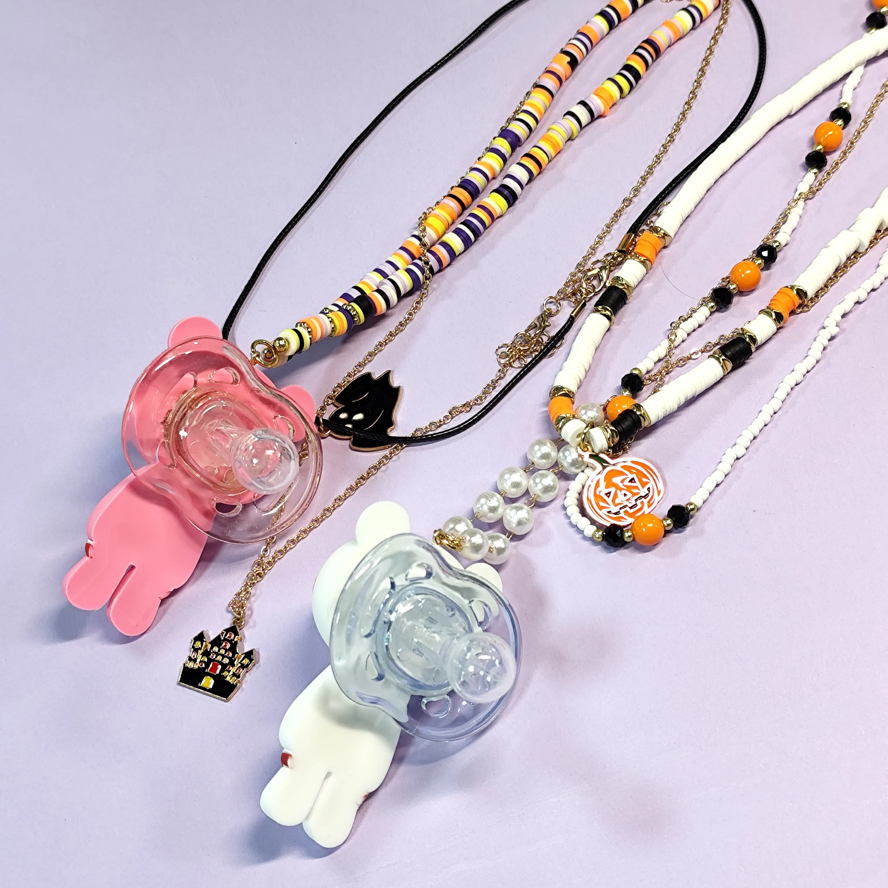 Unique Necklaces with Adult Pacifiers Shaped Like Cute Figures, Beaded Chains, and Halloween-Themed Charms.
