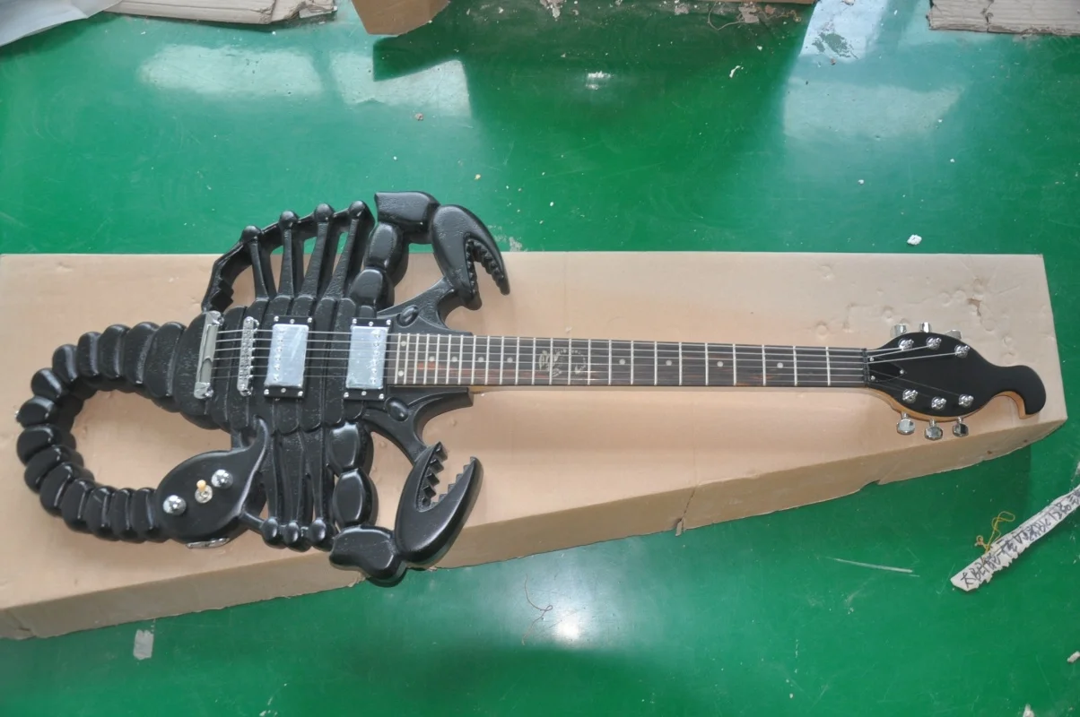 The factory customized 6-string scorpion shaped electric guitar is available in black stock.