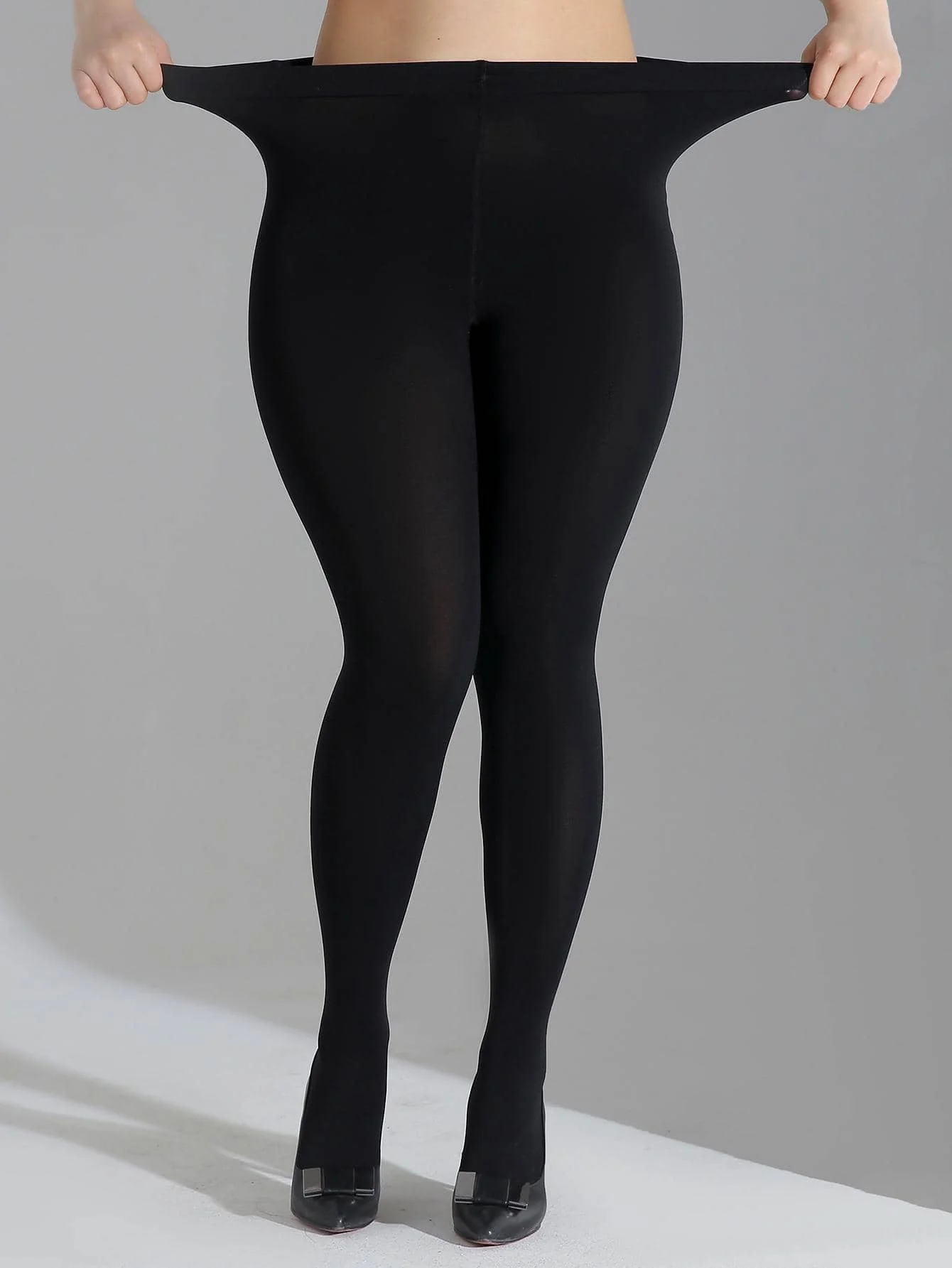 A fashionable women\'s solid black oversized pantyhose