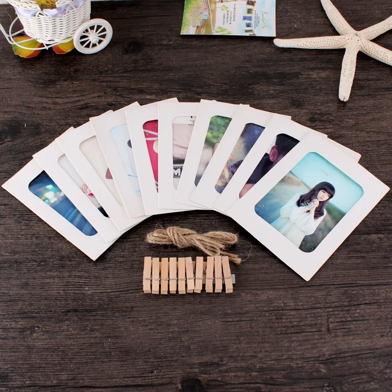A photo wall featuring a combination of 10 34,567-inch vintage cowhide hanging paper frames with hemp rope clips