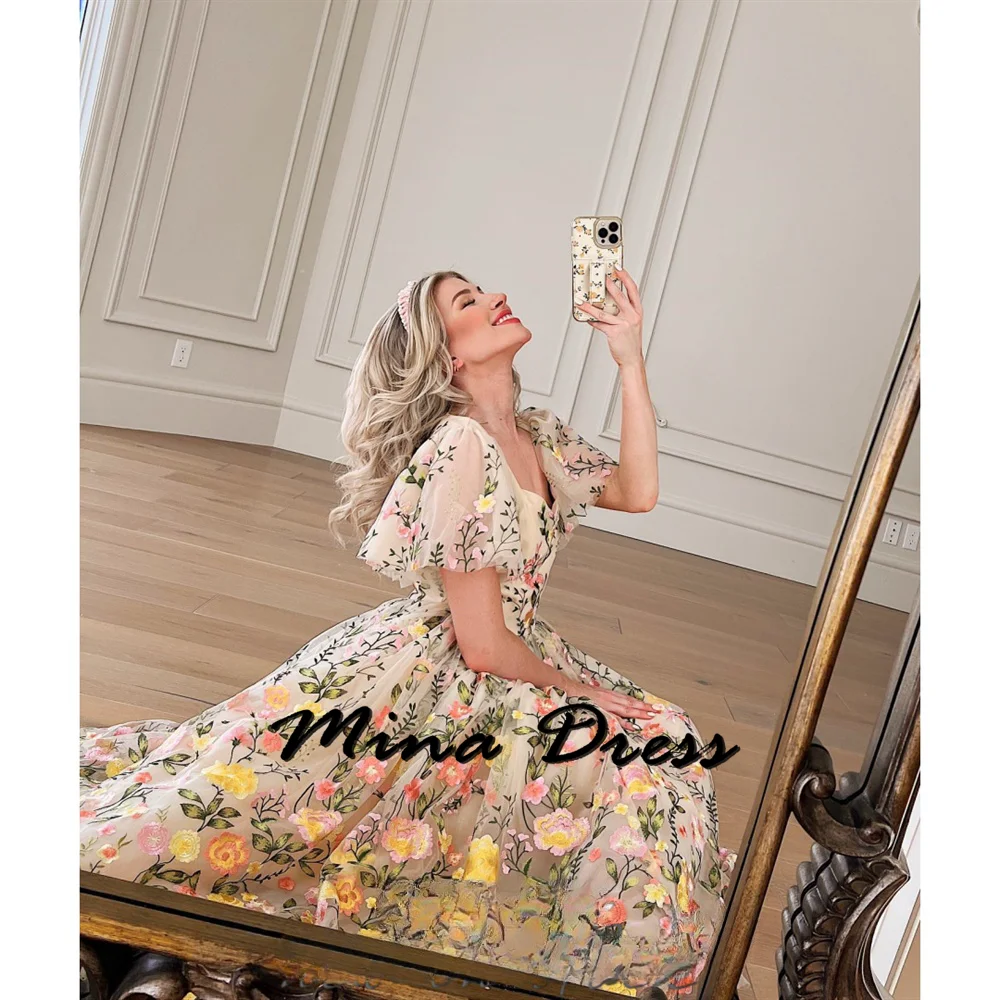 Mina-2024-The sheer dress features embroidered flowers, linen short sleeves, and elegance