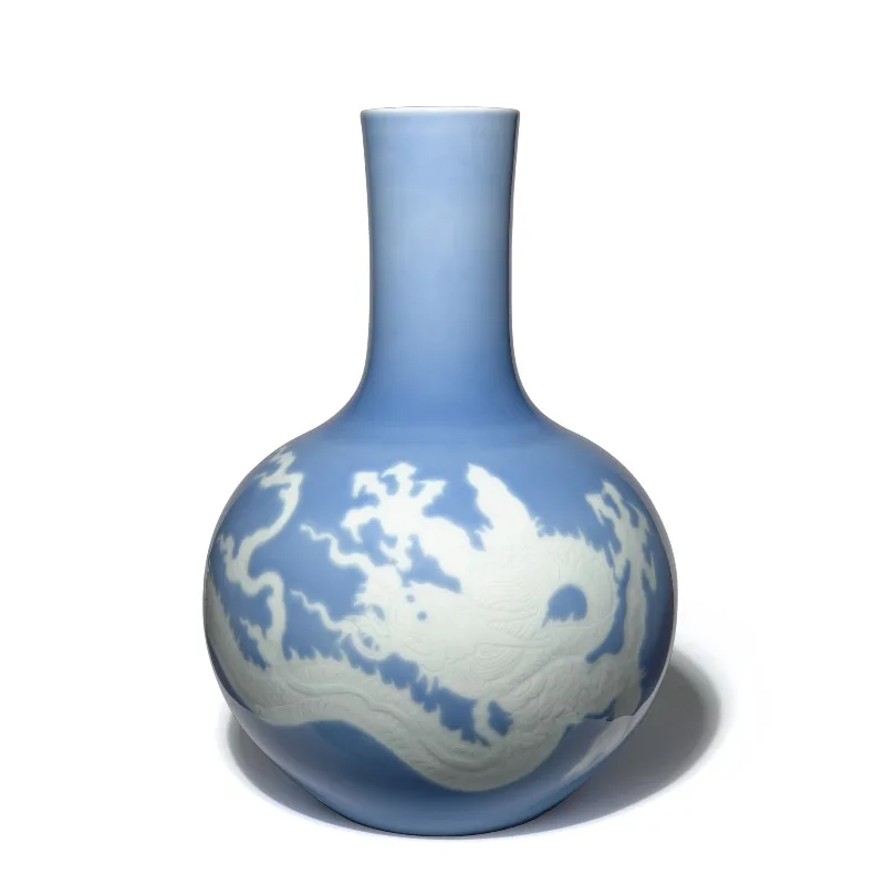 The study is equipped with a large vase, all handmade sky blue glaze engraved with dragon patterns and filled with white