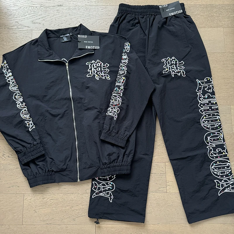بلوزات عاطفة مختلطة Sweatpants عالية الجودة طباعة الماس الثقيل 2025 جديد الرجال النساء زوجين ملابس الشارع الشهير سترة السراويل