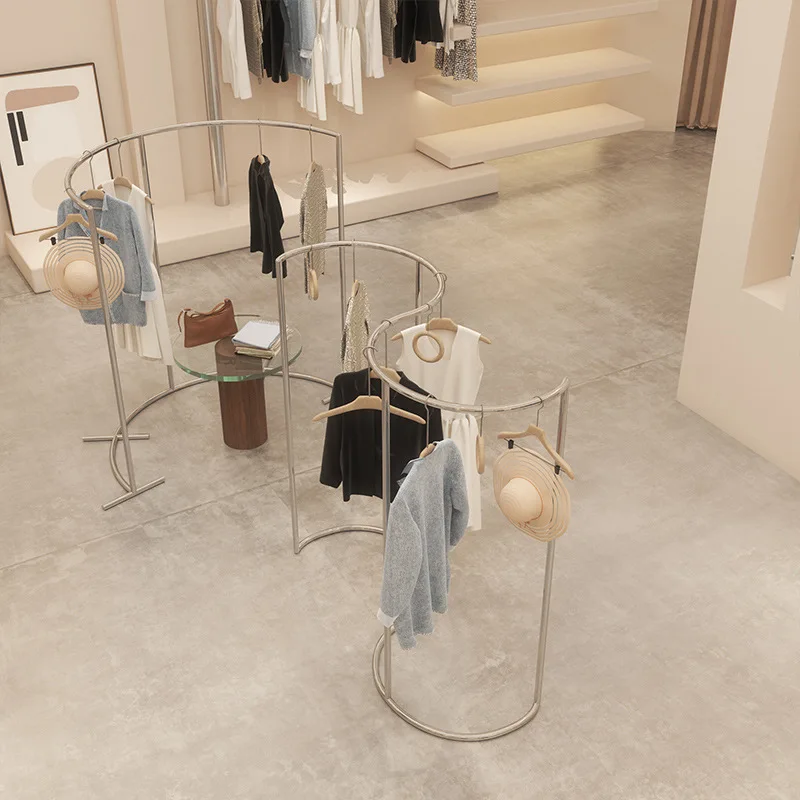 

Clothing store display rack Floor-to-ceiling stainless steel brushed silver curved middle island rack Men's and women's clothing