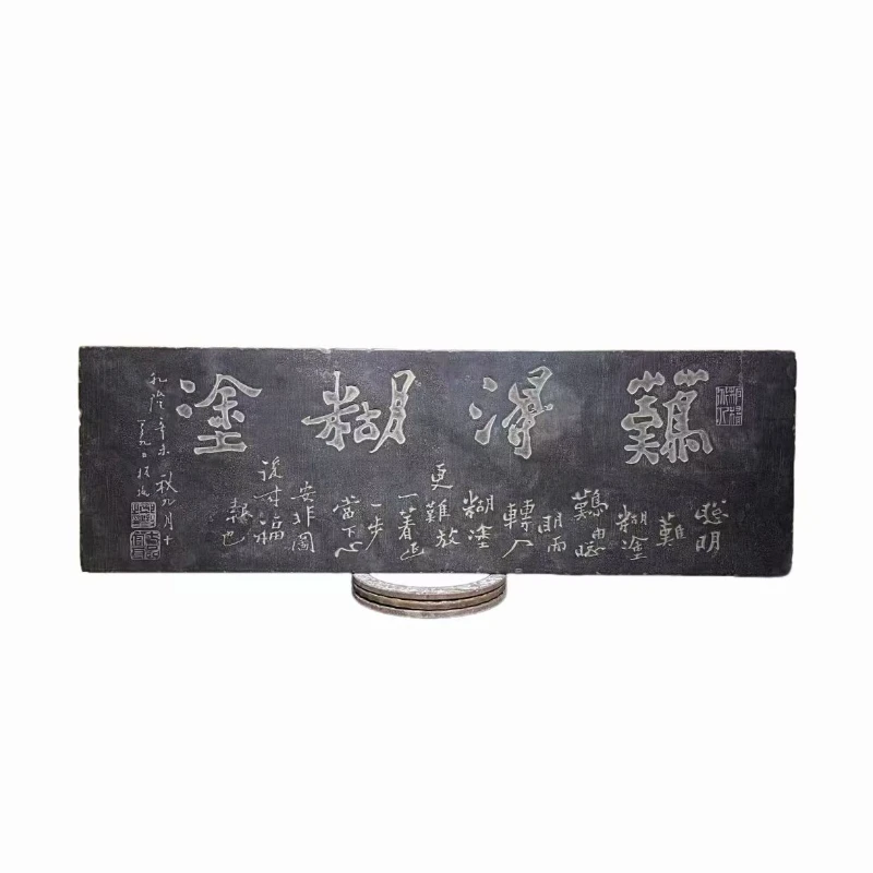 

Stone carving retro slate rubbing ornaments are old and placed on the wall of the home living room