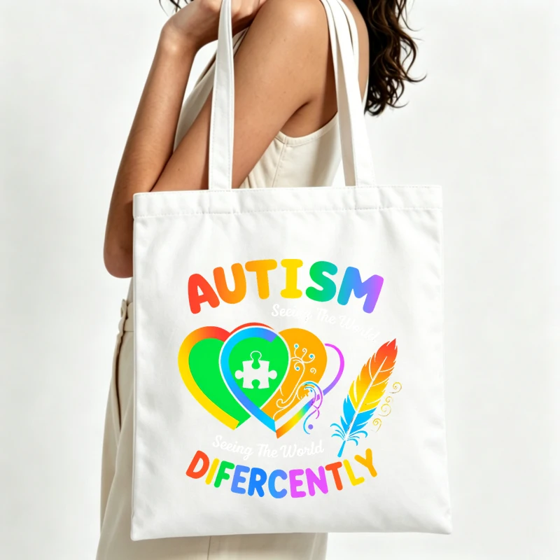 Women's autism awareness canvas tote bag with heart and puzzle graphic, ideal for casual daily use and community events
